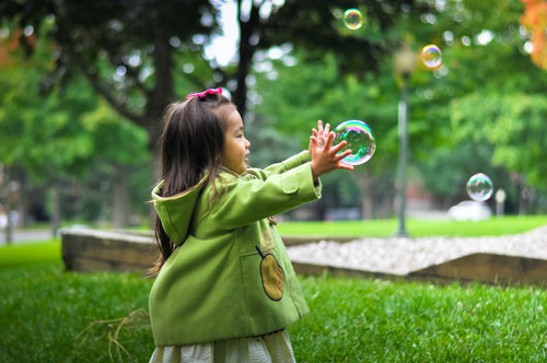 Child Playing with Bubbles Photo from Unsplash.com